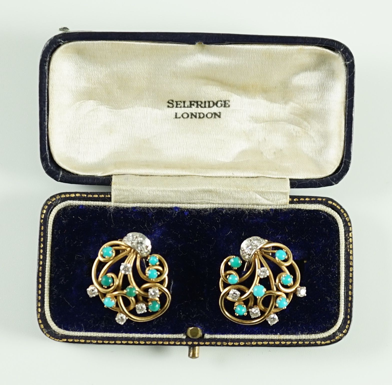 A pair of modern 18k gold diamond and turquoise cluster set scrolling ear clips